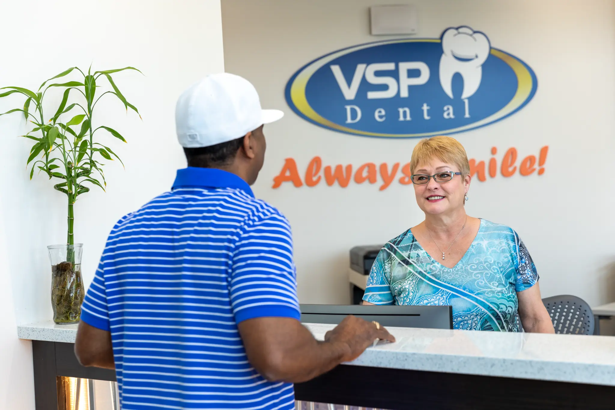 Patient speaking with a VSP Dental team member at checkout