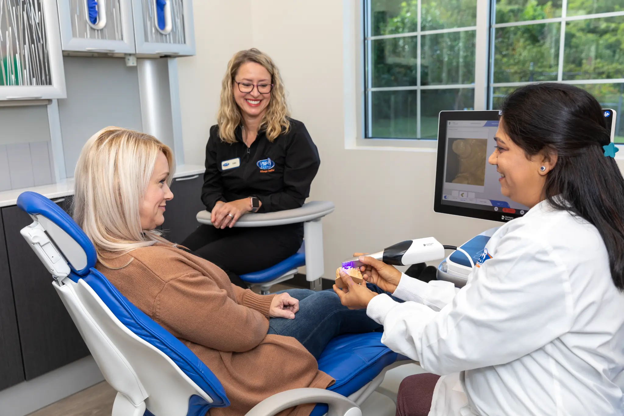 VSP Dental clinician reviewing a veneer shade guide with a patient